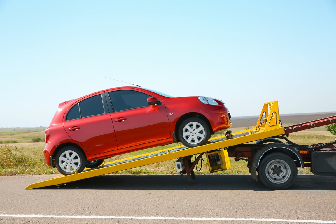 Tow Truck with Broken Car on Country Road