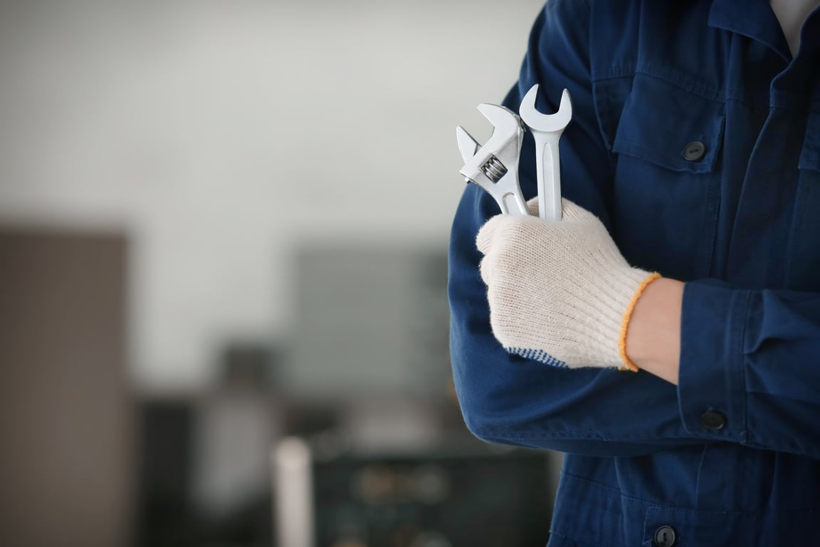 Mechanic with Tools in Car Repair Shop